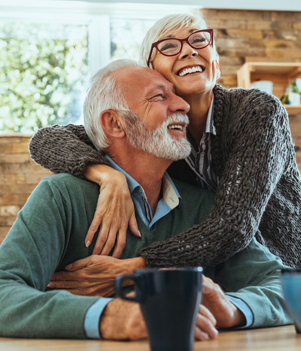 mature couple smiling in the kitchen together